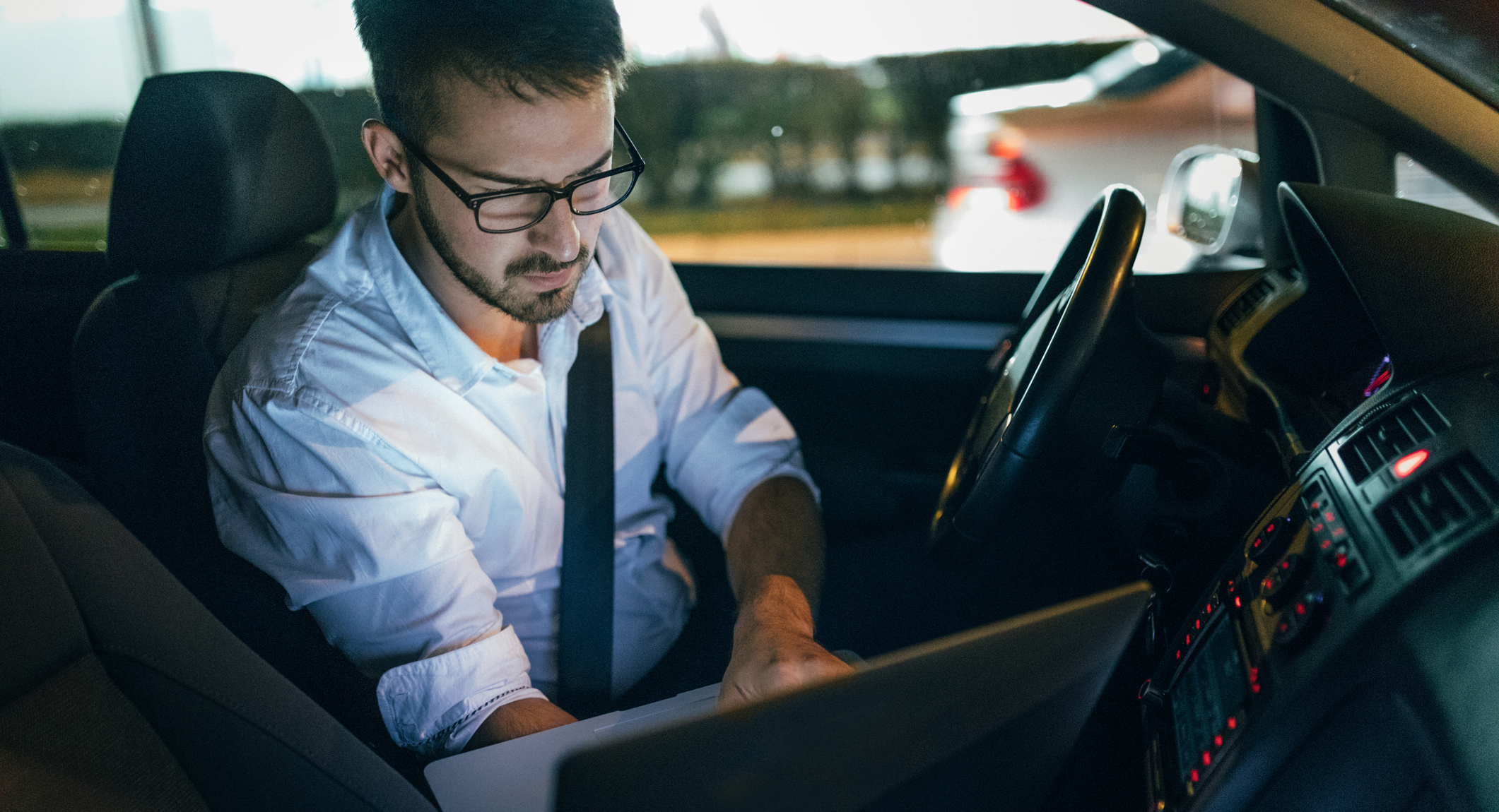 Man using laptop in car